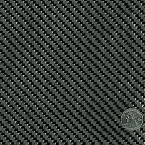 Square swatch of twill weave carbon fiber fabric with a quarter sitting in corner for size reference.