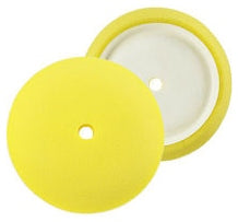 Two yellow buffing pads with hole in the middle showing the front and back.